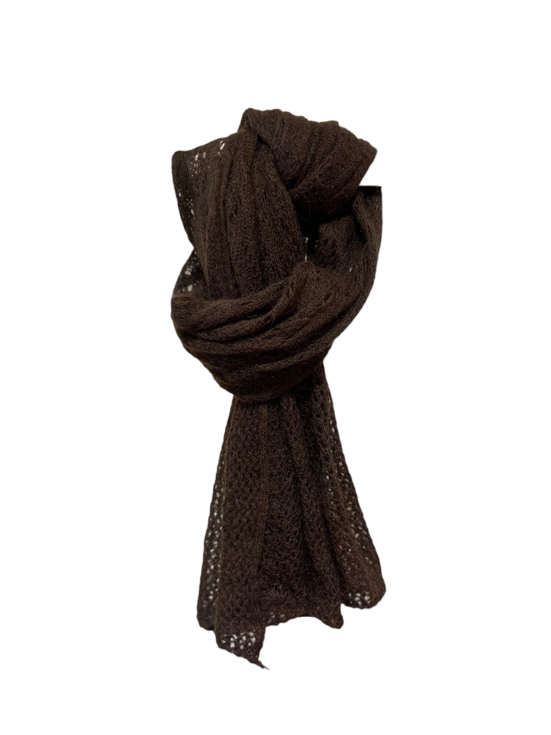 Dark brown knitted scarf on a light beige background