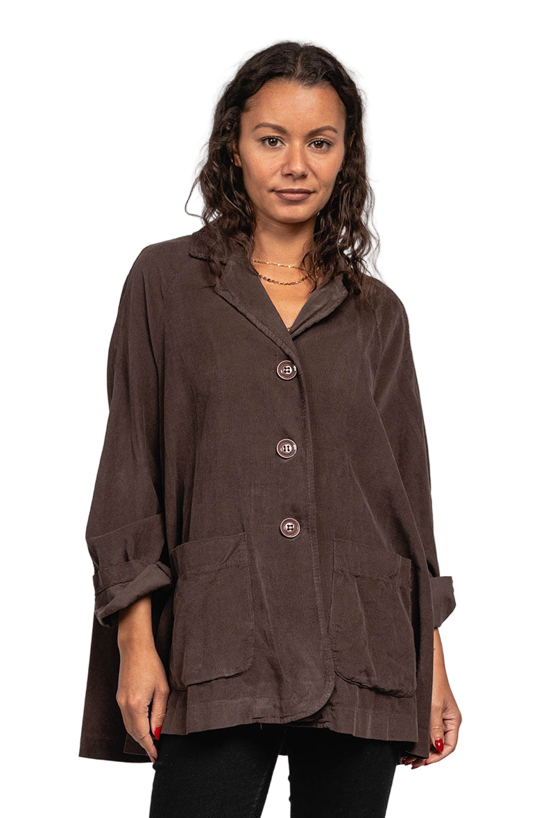 Woman wearing a brown coat against a plain background