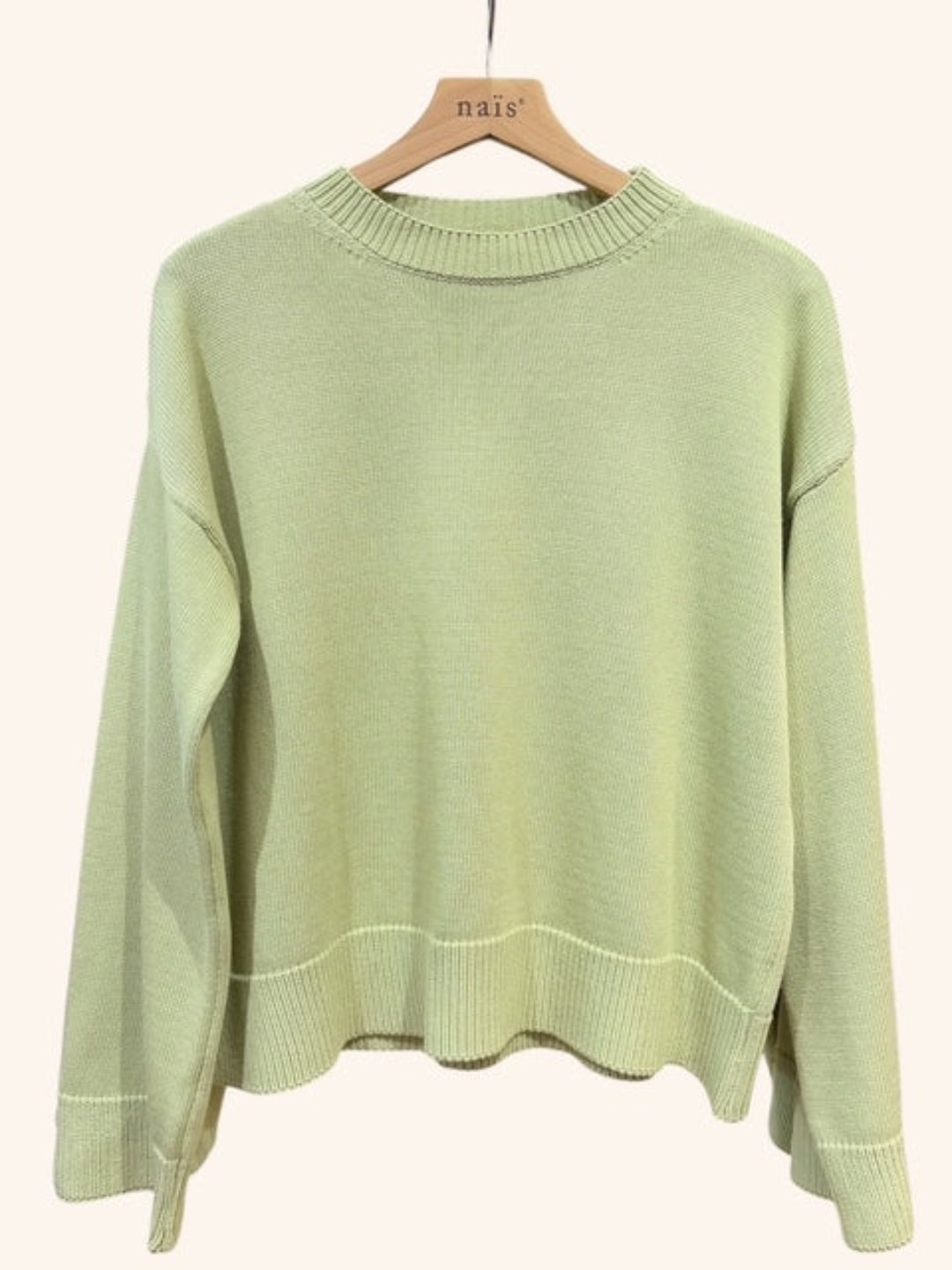 Light green sweater on a hanger
