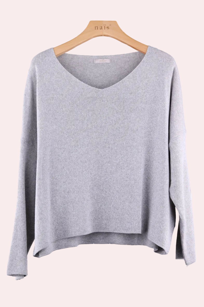 Light grey sweater on a wooden hanger