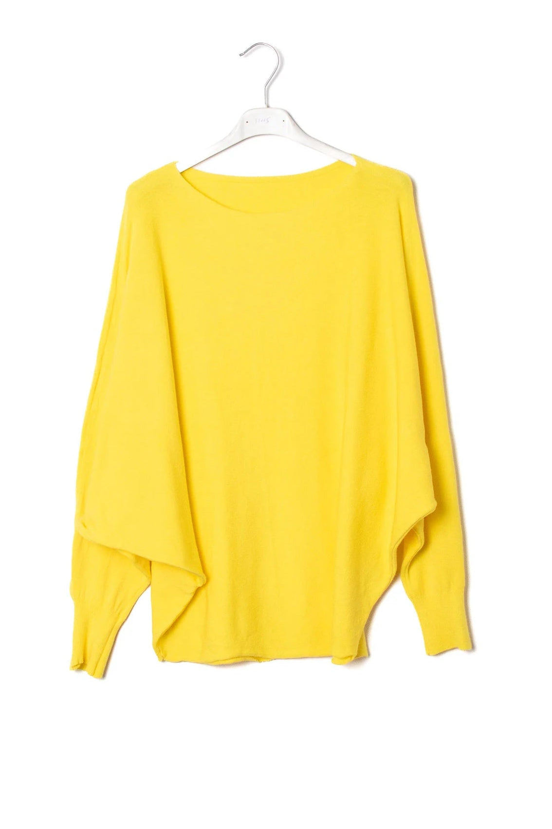 Yellow sweater on a white hanger against a white background