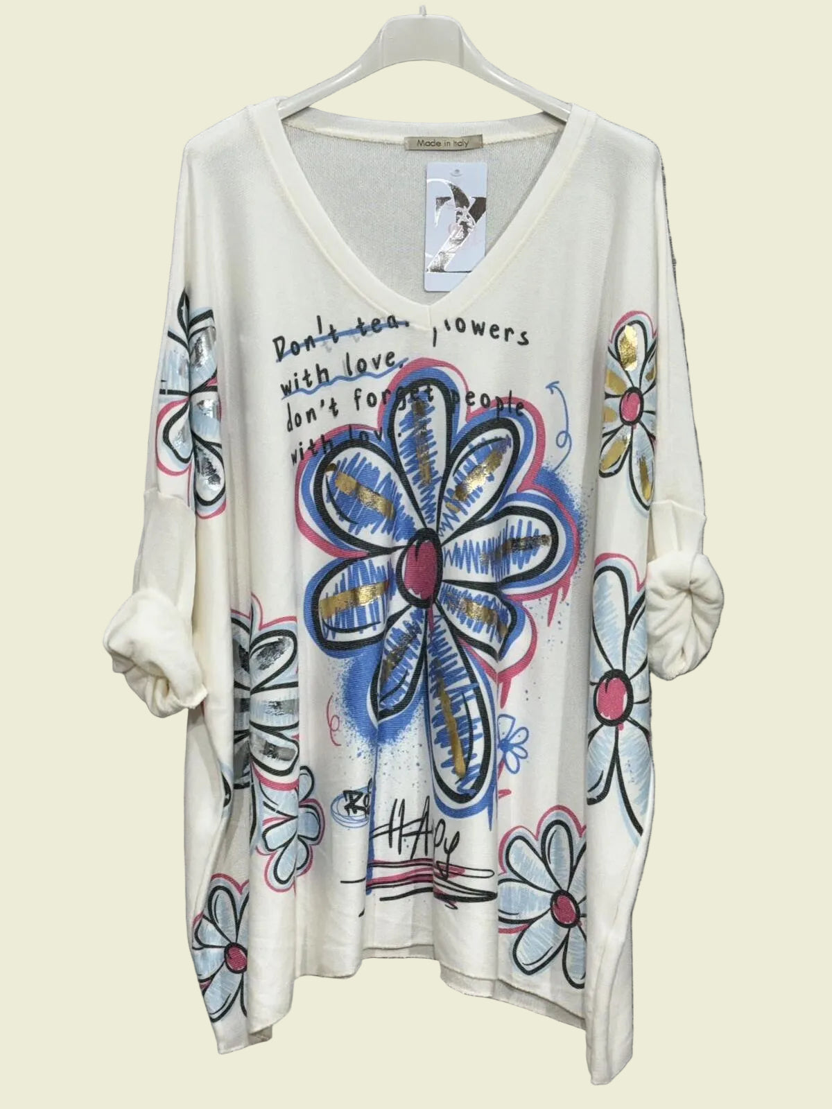 White sweater with colorful floral designs background