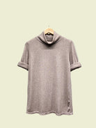 Taupe turtleneck top on a hanger against a neutral background