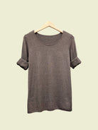 Brown t-shirt on a hanger against a plain background