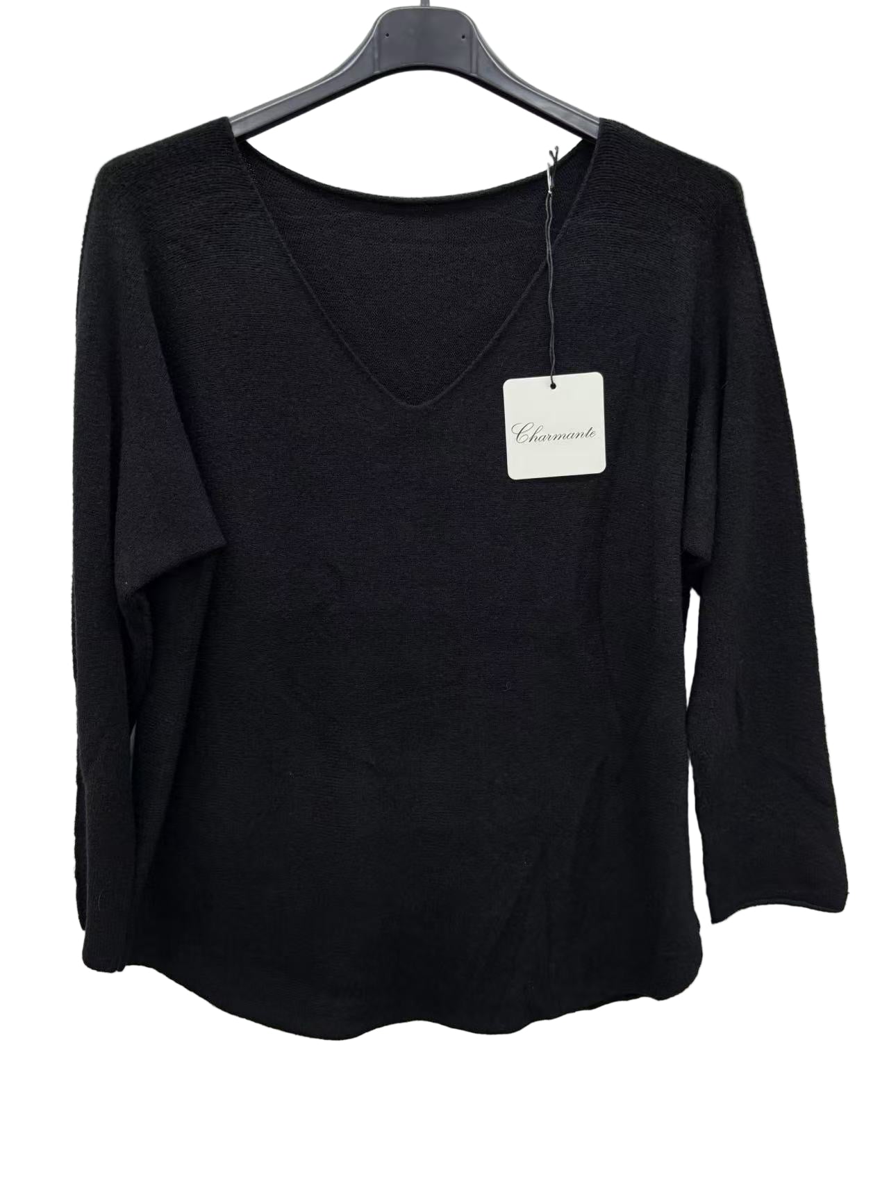 Black long-sleeve top on a hanger with a visible brand tag against a white background
