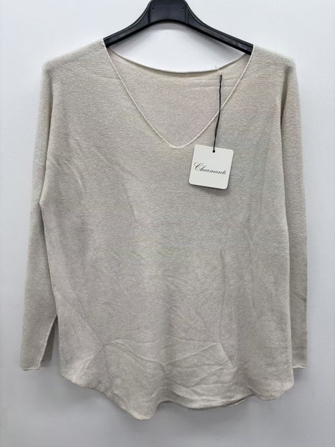 beige sweater on a hanger with a brand tag against a white background