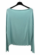 Light blue long-sleeve top on a hanger against a white background