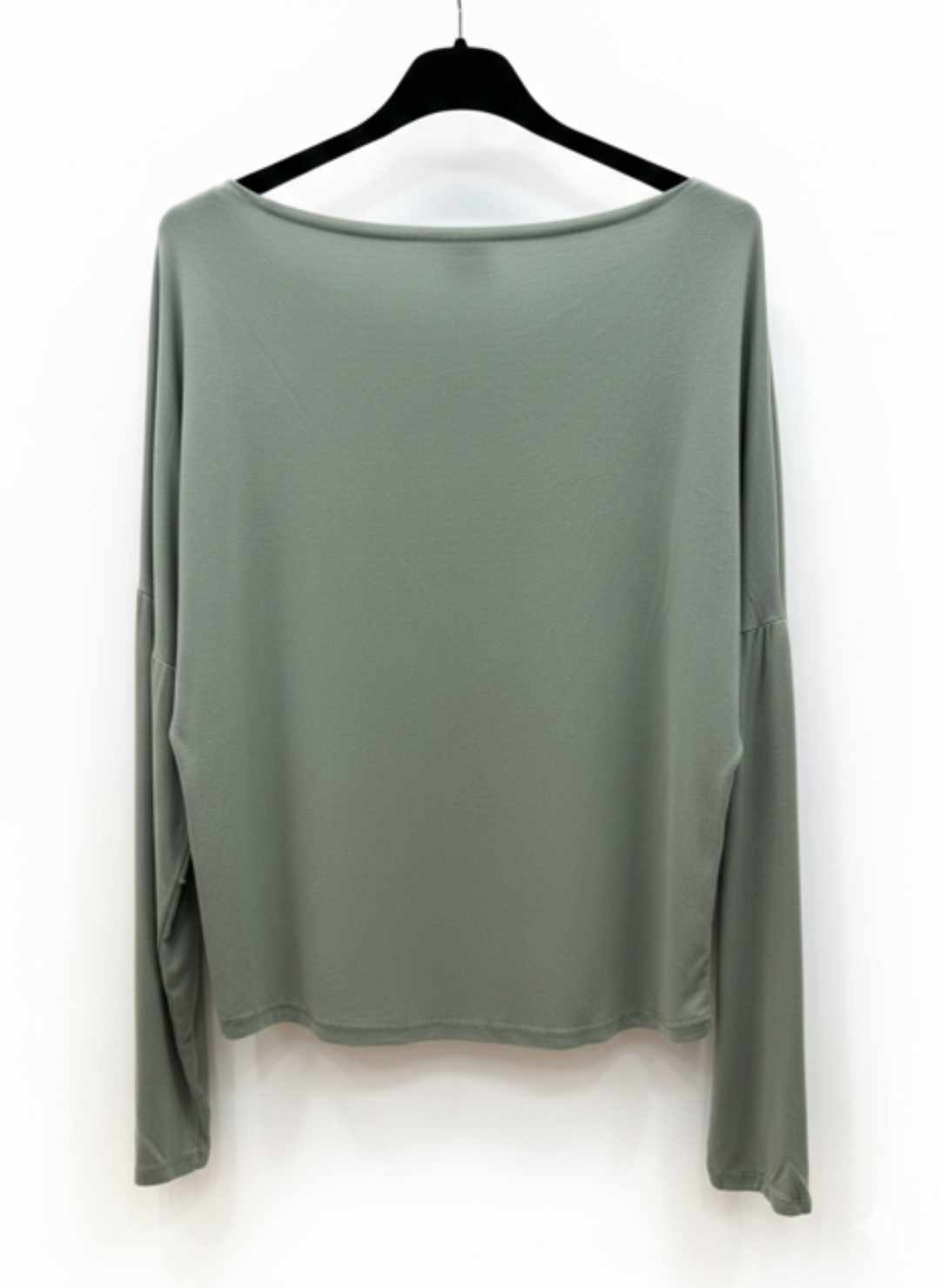 Green long-sleeve top on a hanger against a white background