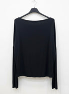 Black long-sleeve top on a hanger against a white background