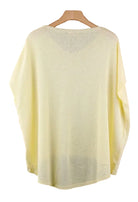 Light yellow top on a wooden hanger 