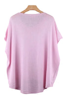 Pink top on a wooden hanger 