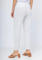 White pants worn by a person on a white background