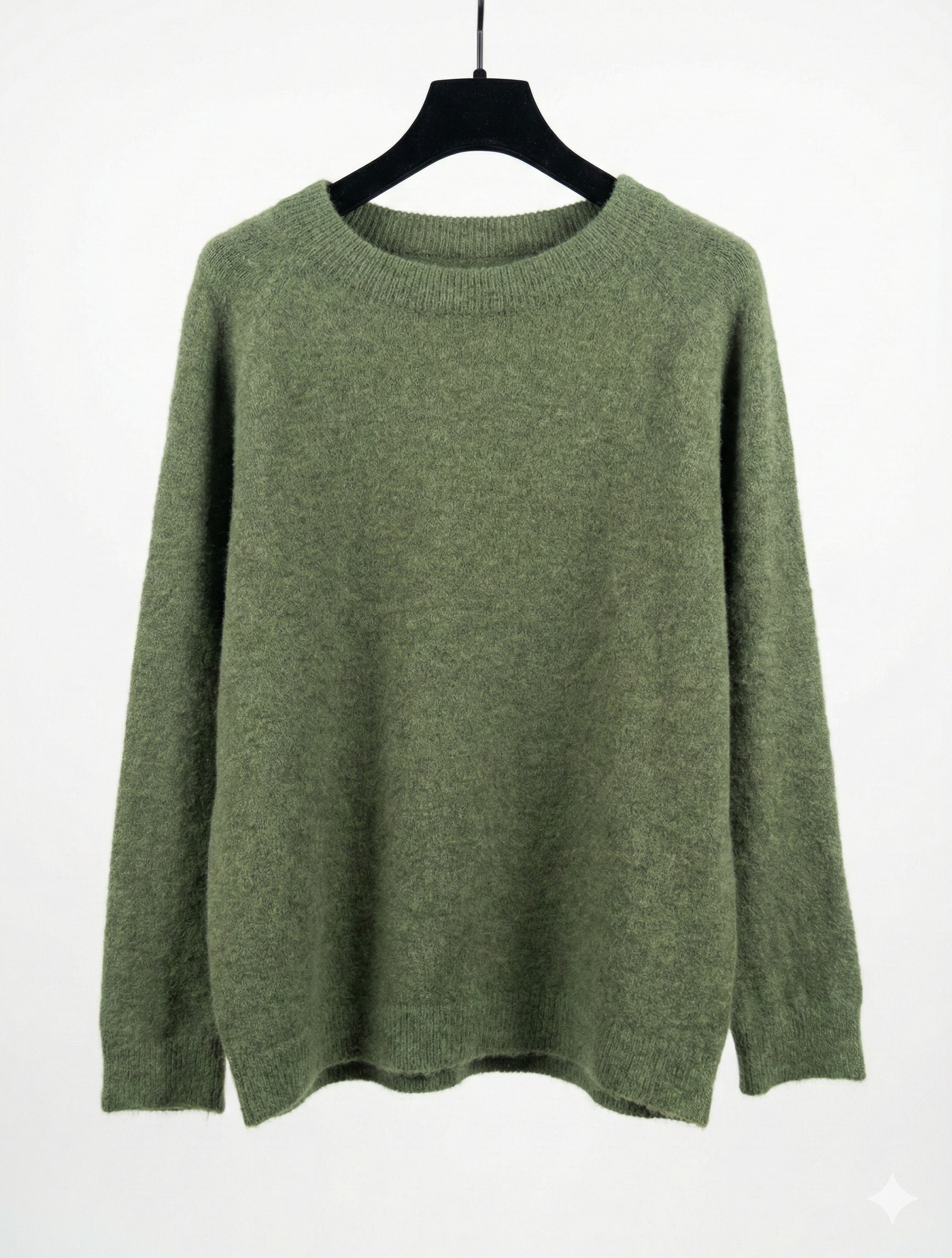 Green sweater on a hanger against a white background