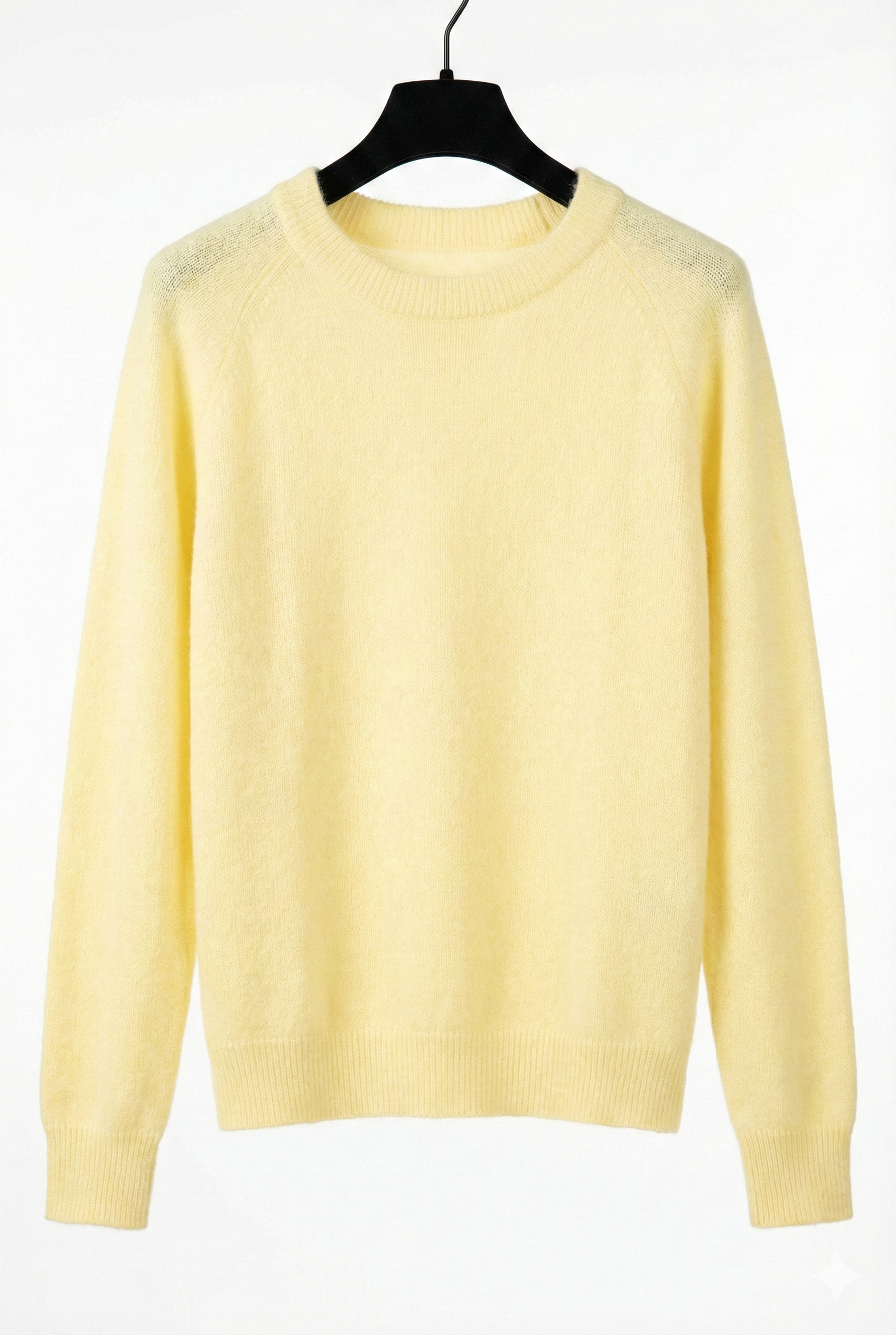 Yellow sweater on a black hanger against a white background