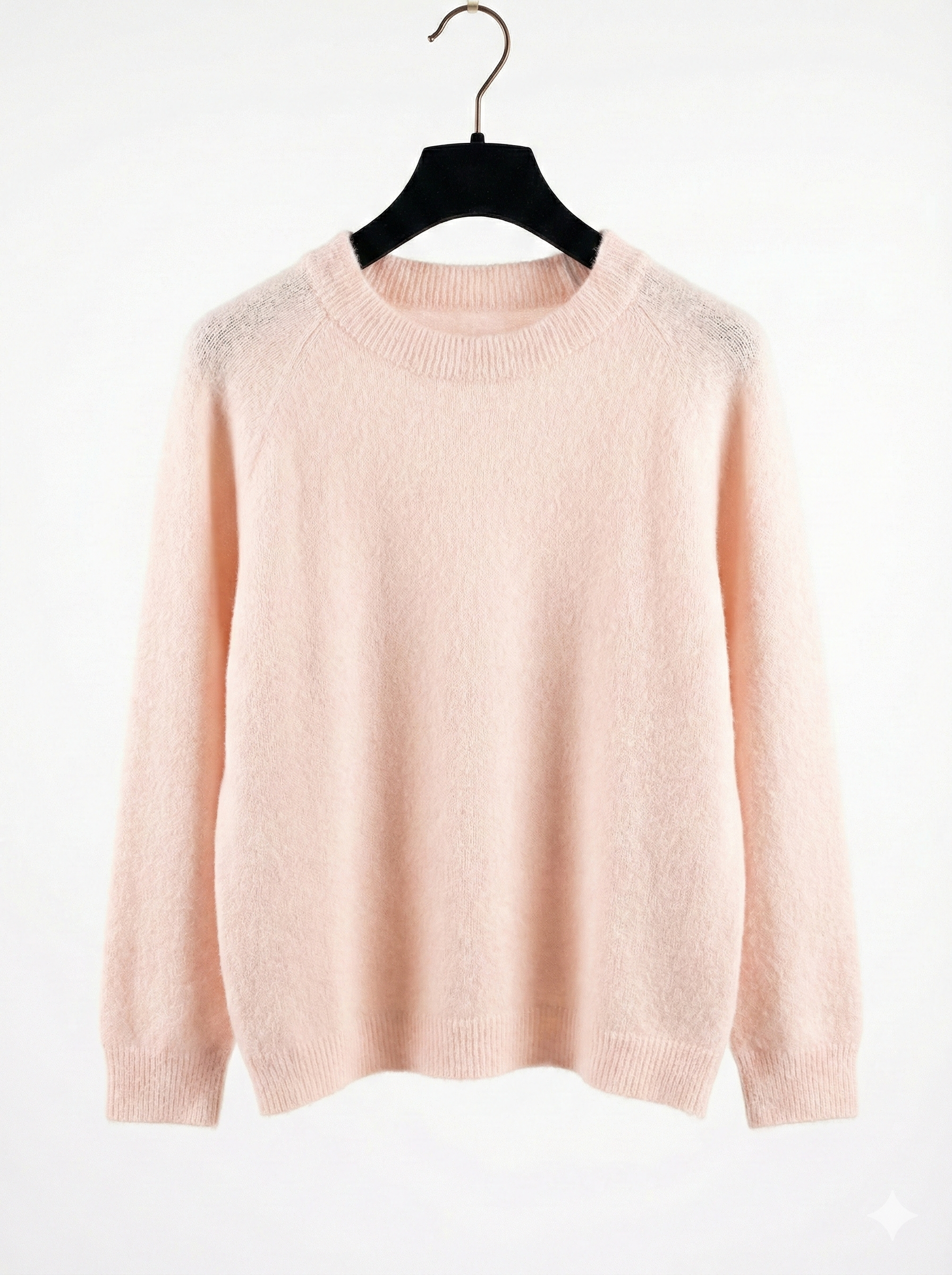 Pink sweater on a hanger against a white background