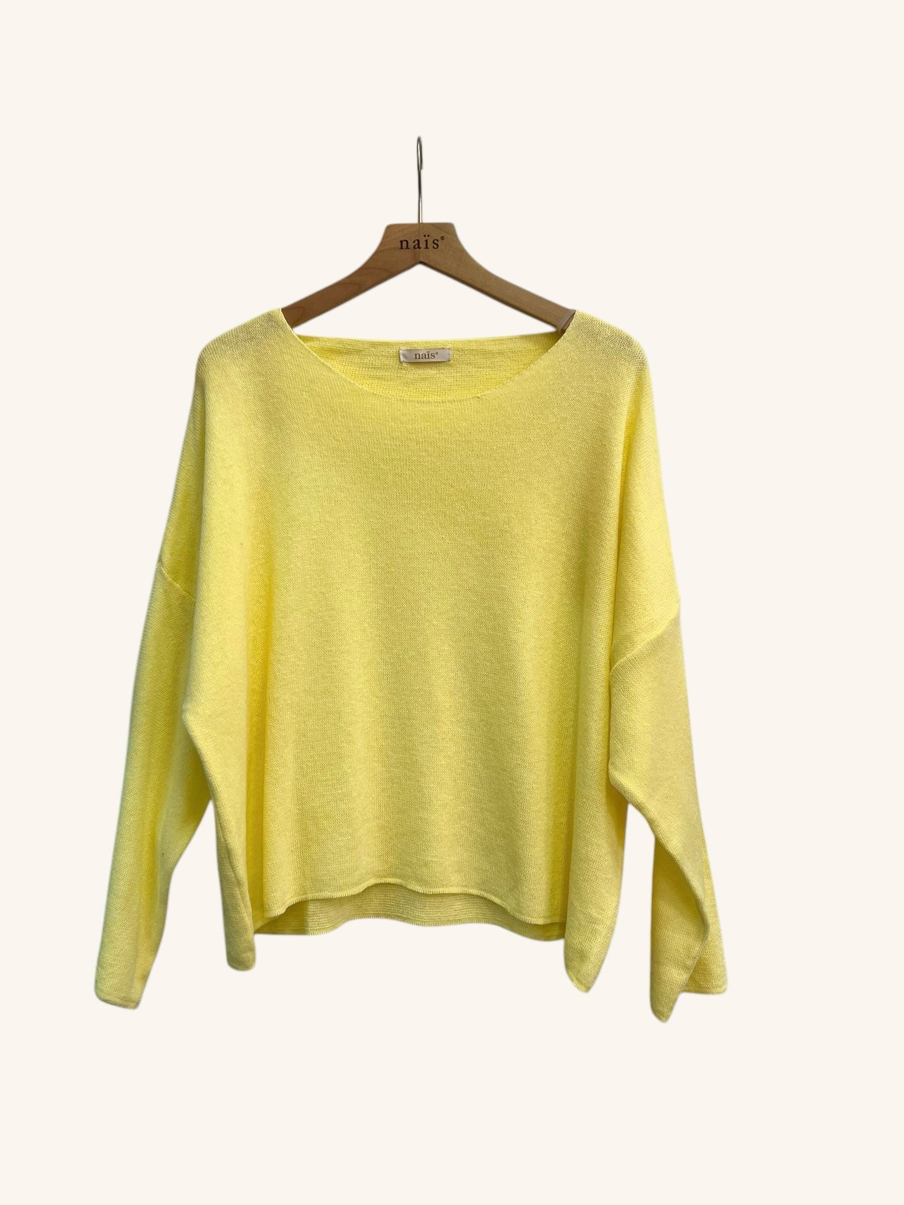 Yellow sweater on a wooden hanger against a white background