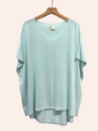 vert d'eau sweater  on a hanger