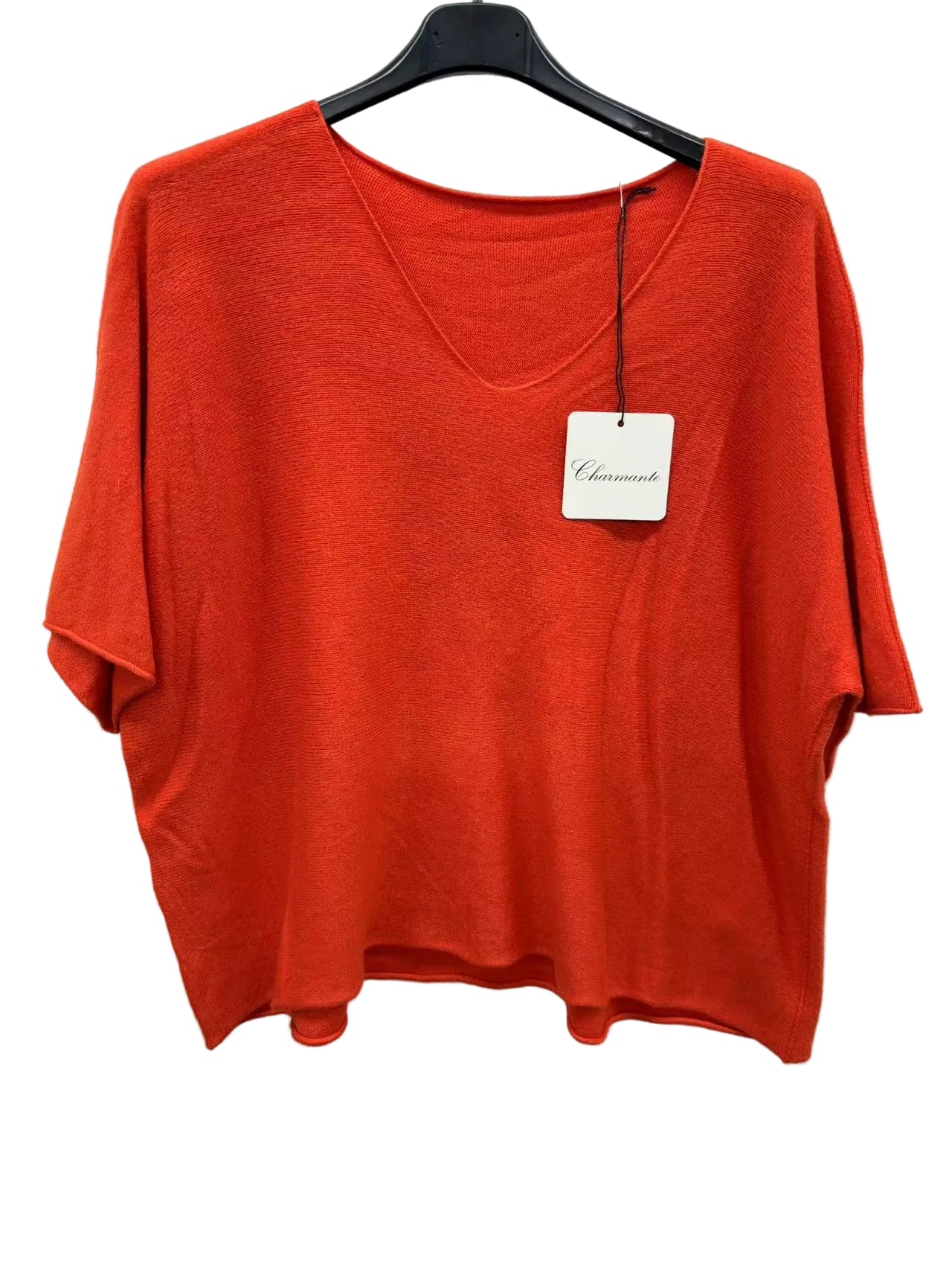 Orange sweater on a hanger 