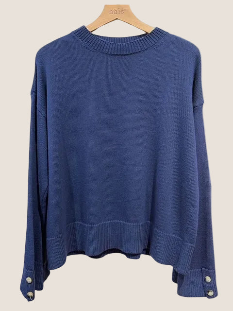 Blue sweater on a hanger against a white background