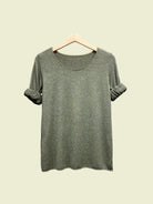 Khaki top on a hanger against a gray background