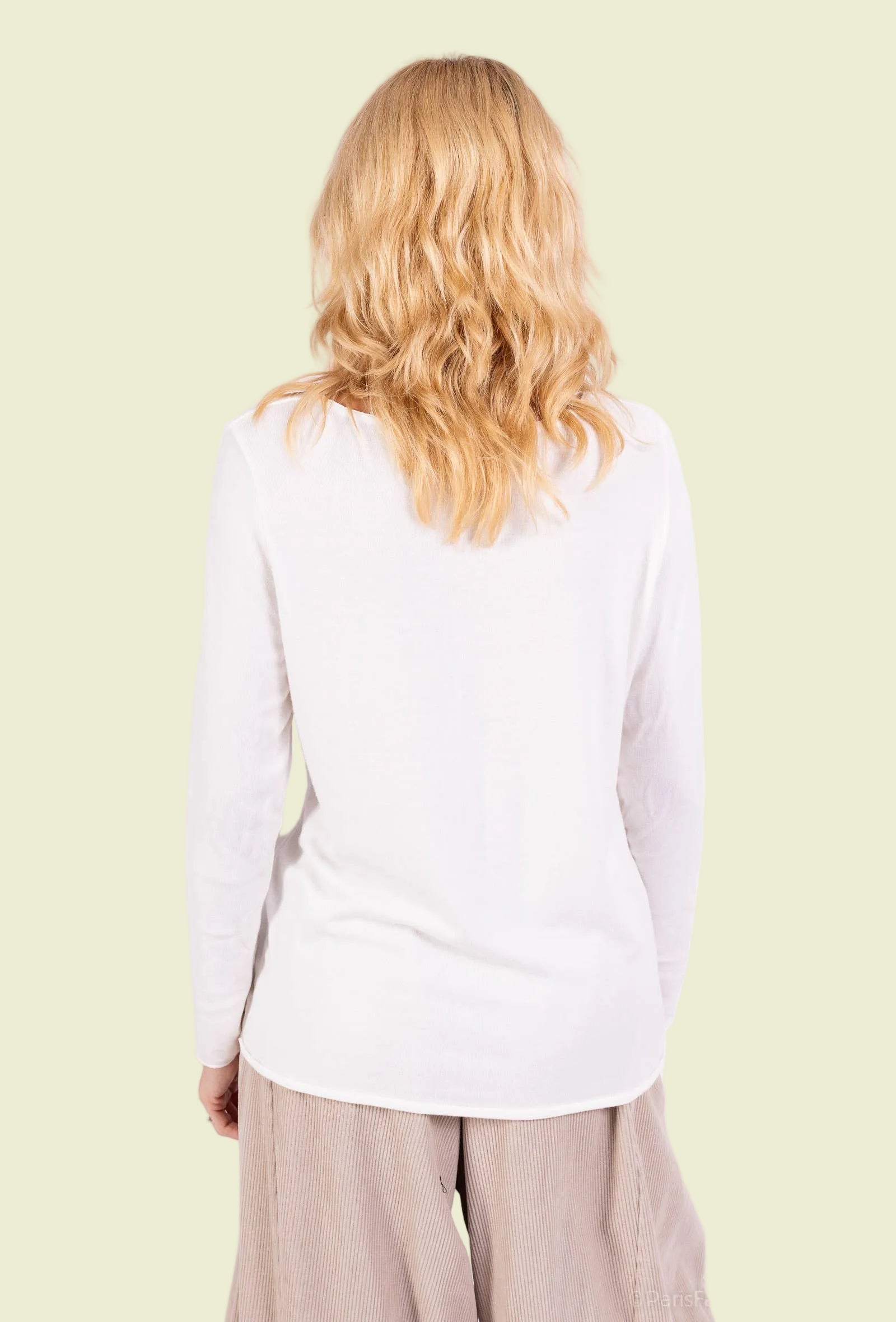 Person wearing a white long-sleeve top