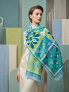 Woman wearing a colorful floral scarf in a modern interior setting