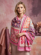 Woman wearing a pink floral patterned scarf against a soft pink background