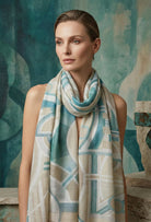 Woman wearing a patterned scarf against a textured teal background