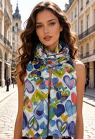 Woman wearing a colorful heart-patterned scarf in an urban setting