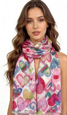 Woman wearing a colorful heart-patterned scarf on a white background