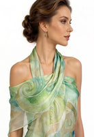 Woman wearing a green and beige patterned scarf on a white background