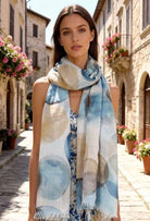 Woman wearing a patterned scarf in an Italian street setting