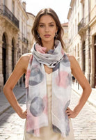 Woman wearing a colorful scarf in an urban setting