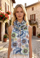 Woman wearing a floral scarf in an Italian village setting