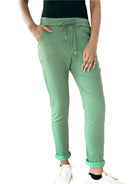 Person wearing green pants with a white background