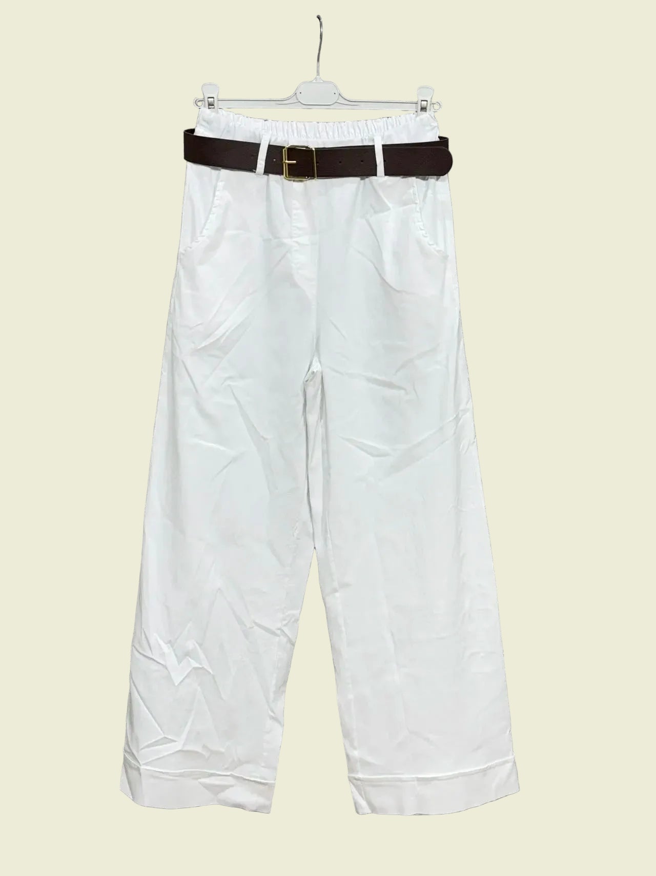 White pants with a brown belt 