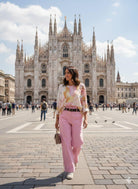 Woman walking in front of the Duomo di Milano in Milan, Italy.