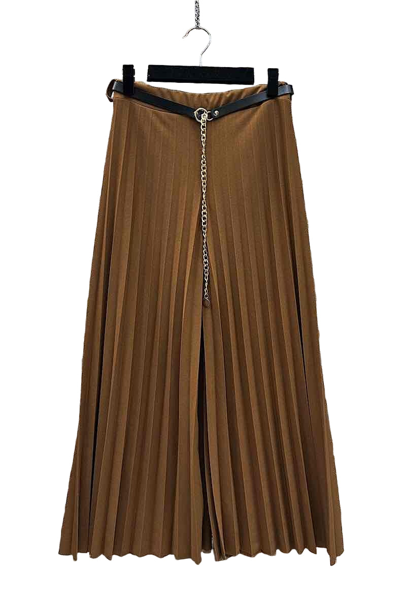Brown pleated skirt with a zipper on a hanger against a stone wall background