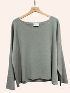 Taupe sweater on a hanger 