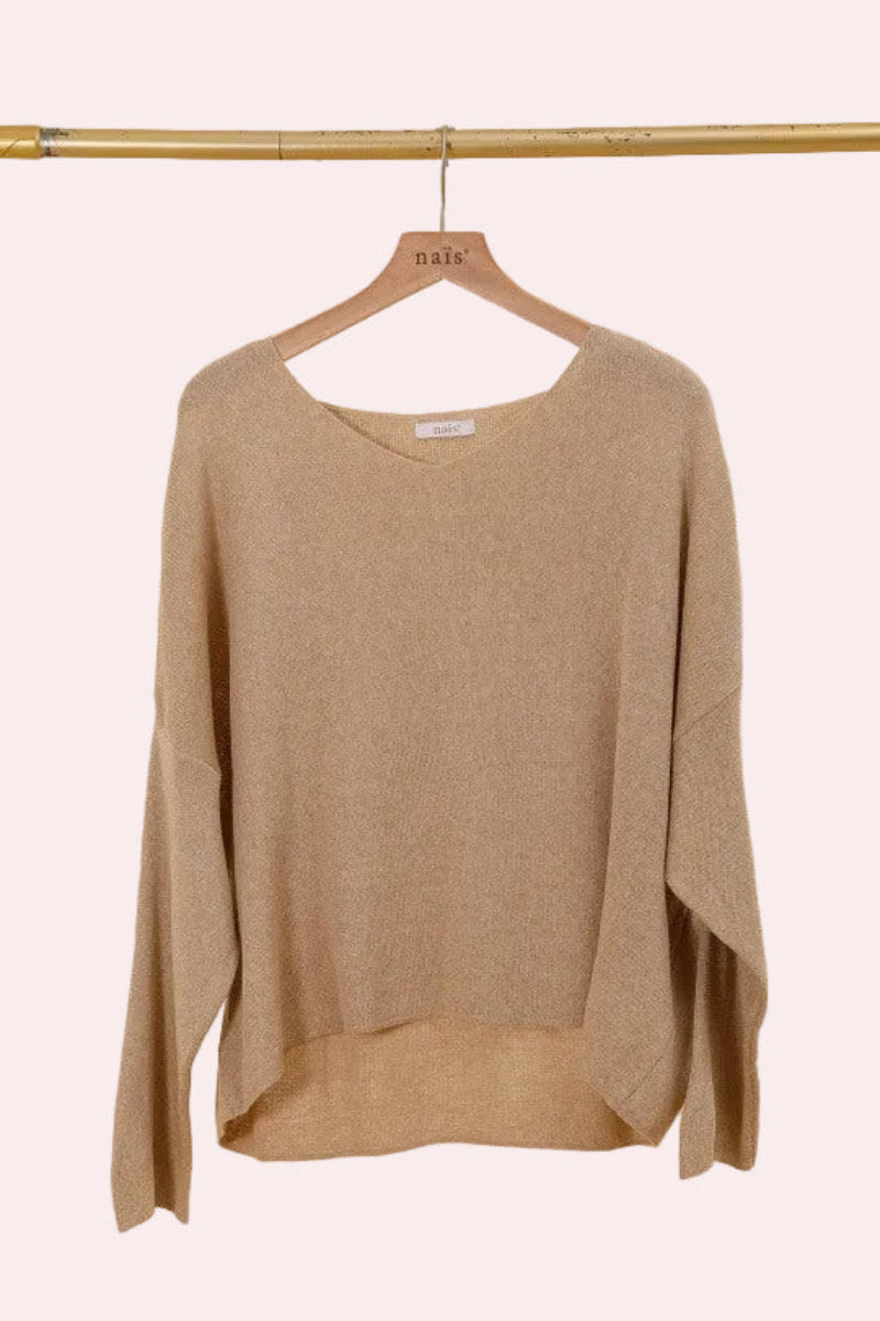 Beige sweater on a hanger against a beige background