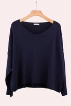 Navy blue sweater on a hanger