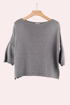 Khaki sweater on a wooden hanger