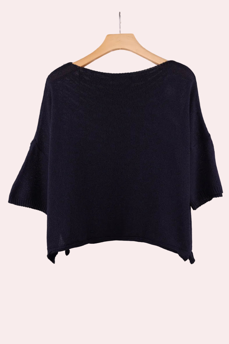 Navy top on a hanger against