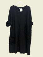 Black dress on a hanger with round neck and feature pockets