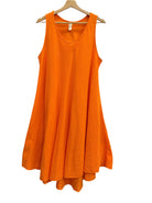 Orange sleeveless dress on a hanger against a white wall.