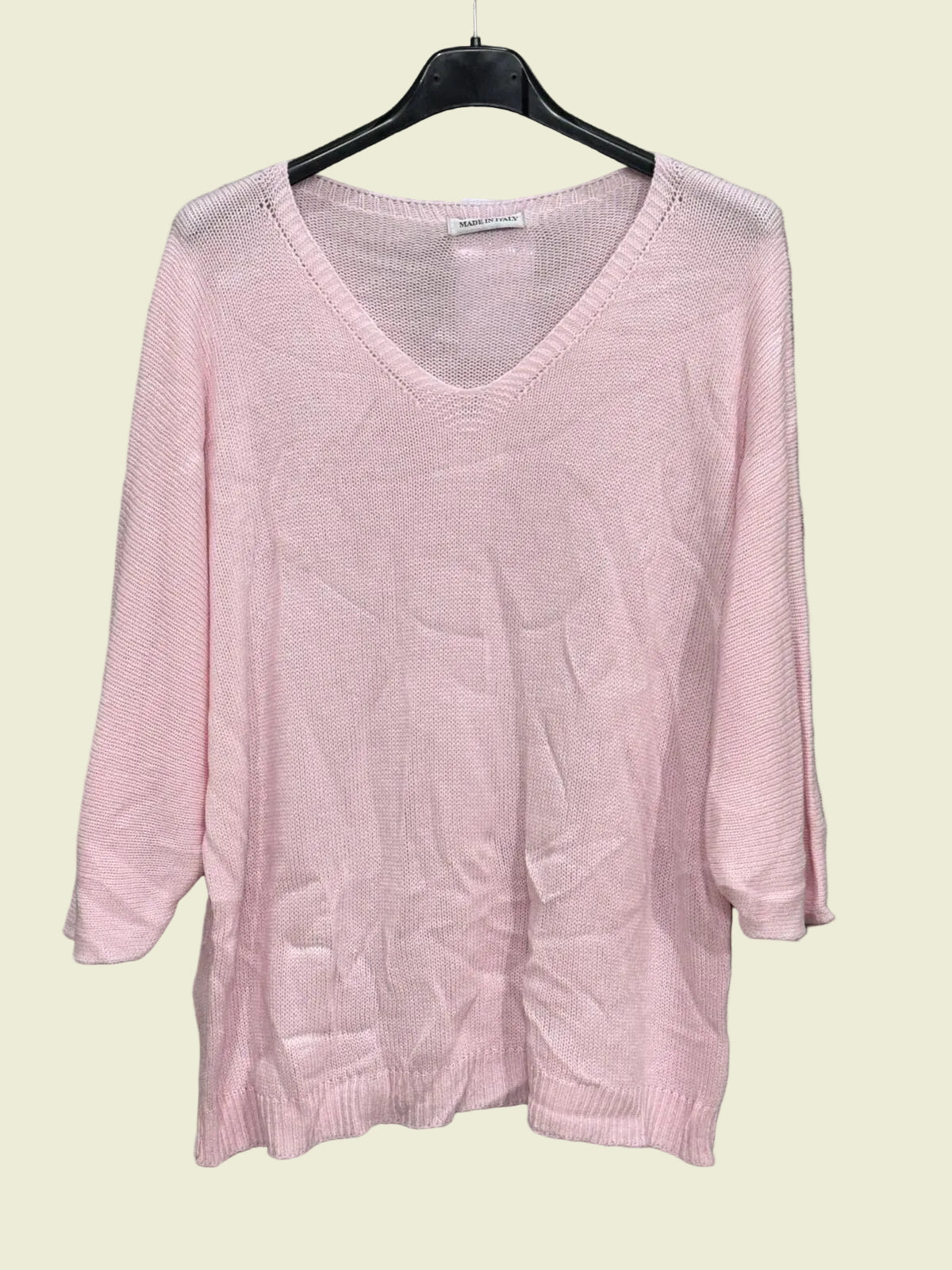 Pink sweater on a hanger 
