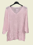 Pink sweater on a hanger 