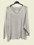 Beige sweater on a hanger 