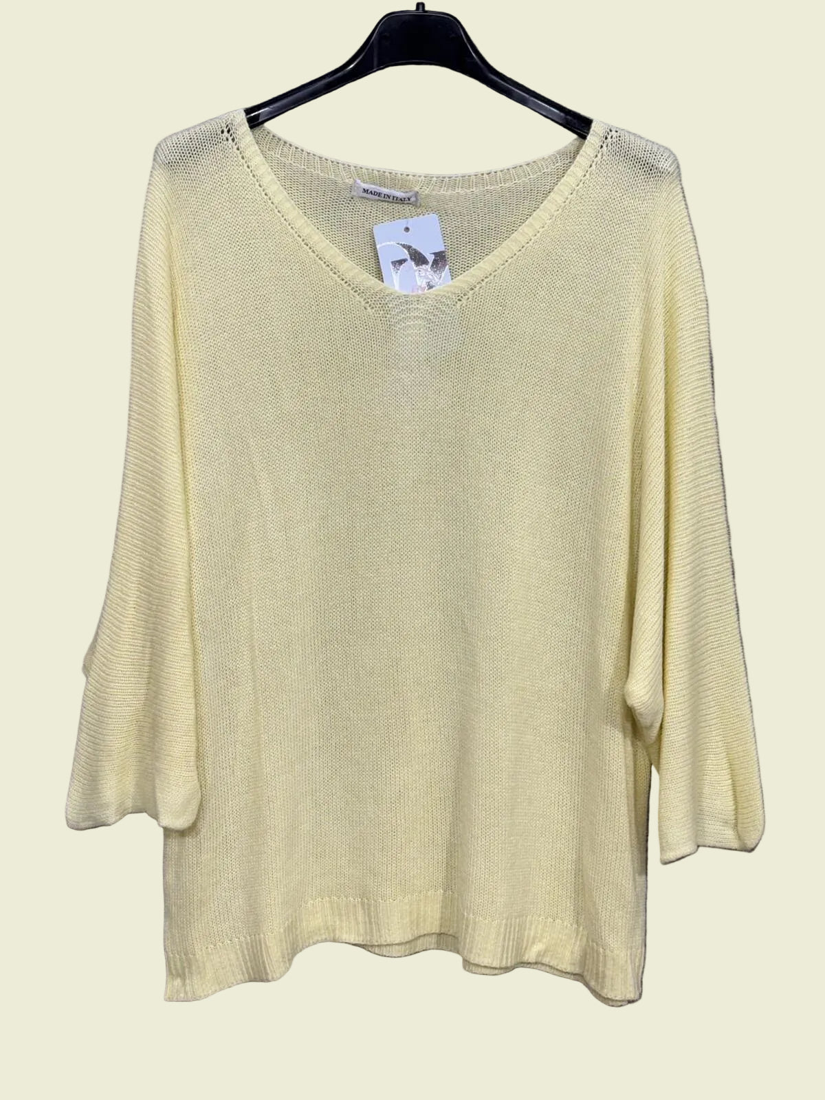 Light yellow sweater on a hanger 
