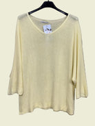 Light yellow sweater on a hanger 